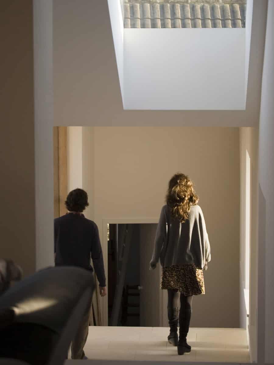 Skylit corridor inside Vale Farm barn conversion with natural light flooding split-level interior